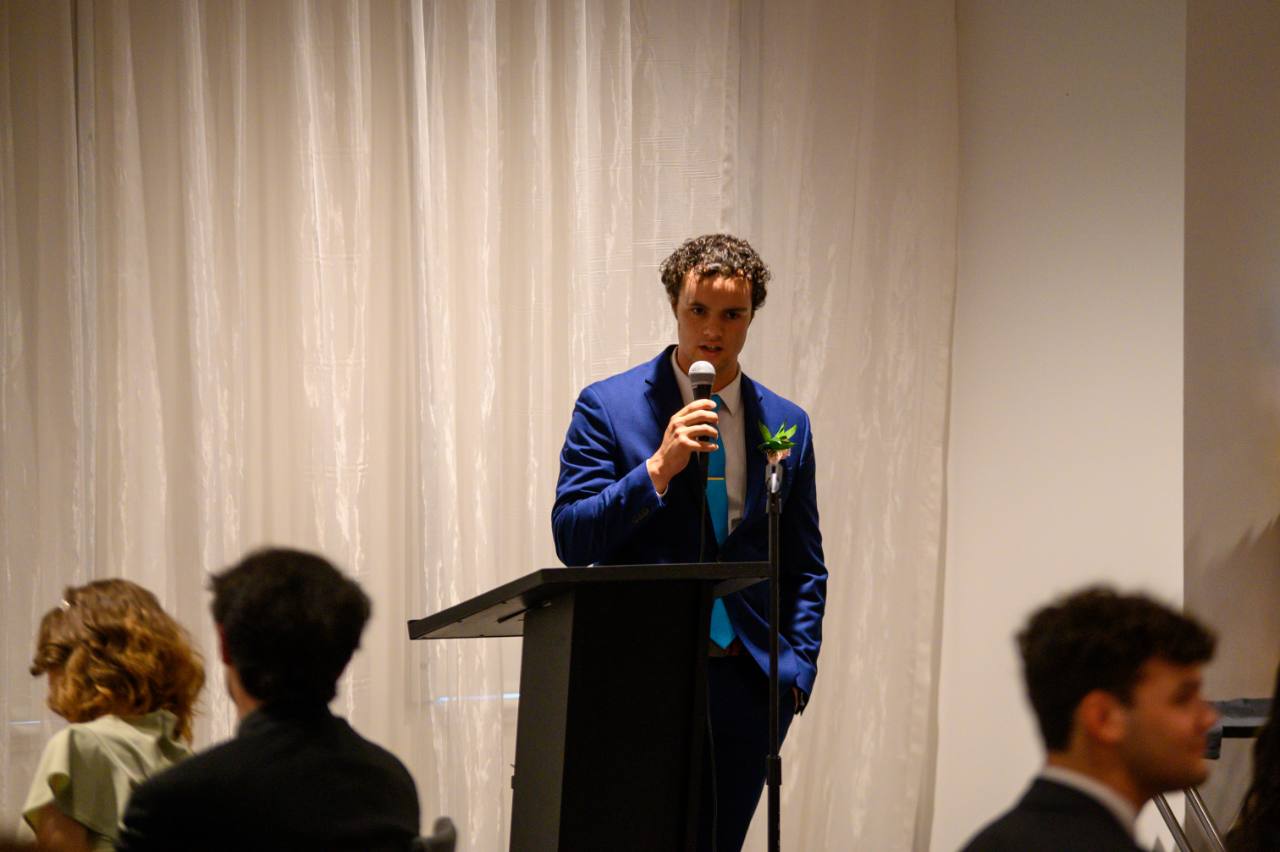 Peter Fast delivering a prepared speech at his 2023 high-school senior gathering